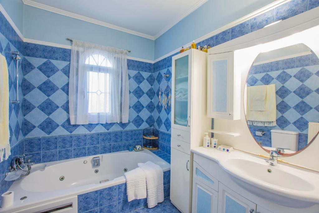 Blue tiled bathroom with bathtub