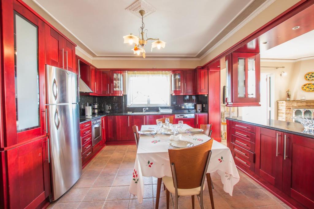 Spacious kitchen with red cabinets